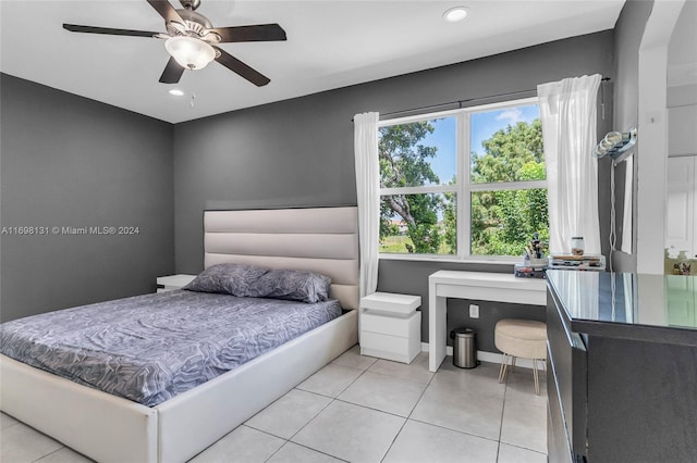 tiled bedroom featuring ceiling fan