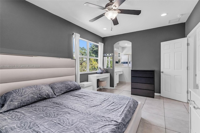 bedroom featuring ensuite bathroom, ceiling fan, and light tile patterned flooring