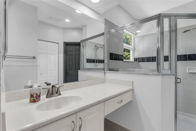 bathroom featuring vanity and an enclosed shower