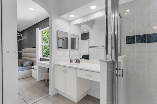 bathroom featuring tile patterned flooring, vanity, and an enclosed shower