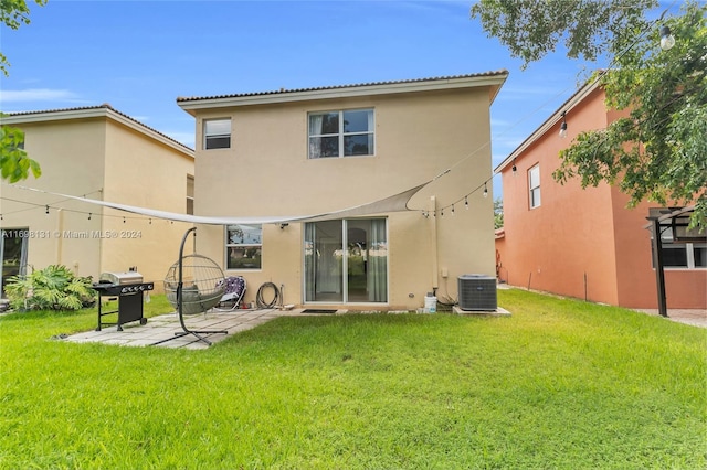 back of house with a patio area, a yard, and central AC unit