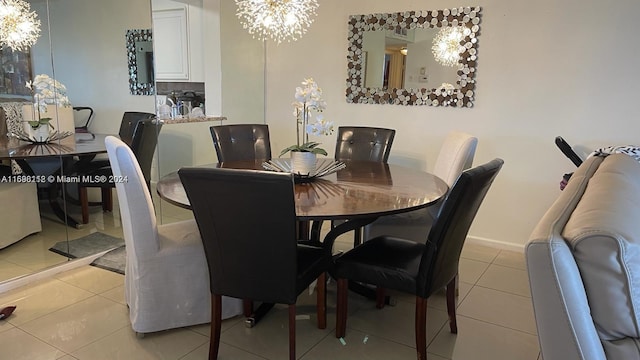 tiled dining space featuring an inviting chandelier