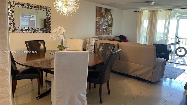 dining space featuring tile patterned floors and an inviting chandelier