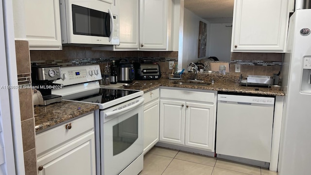 kitchen featuring white cabinets, white appliances, and sink