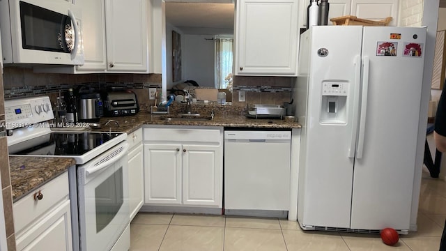 kitchen with white cabinets, white appliances, and light tile patterned flooring