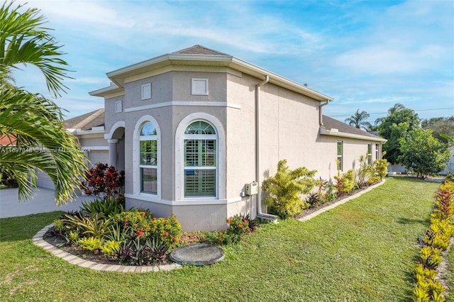 view of side of home featuring a lawn