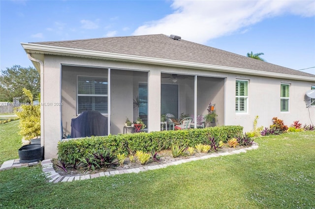 view of property exterior with a lawn and a sunroom