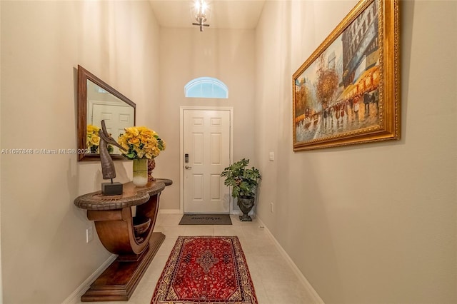 entryway with a high ceiling and light tile patterned floors