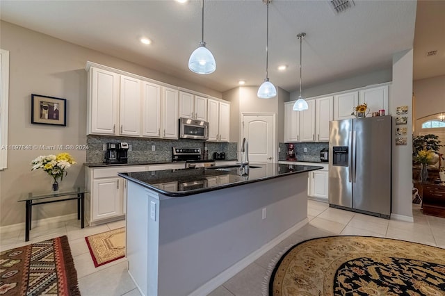 kitchen with white cabinets, an island with sink, and appliances with stainless steel finishes