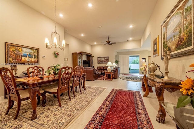 tiled dining room with ceiling fan with notable chandelier