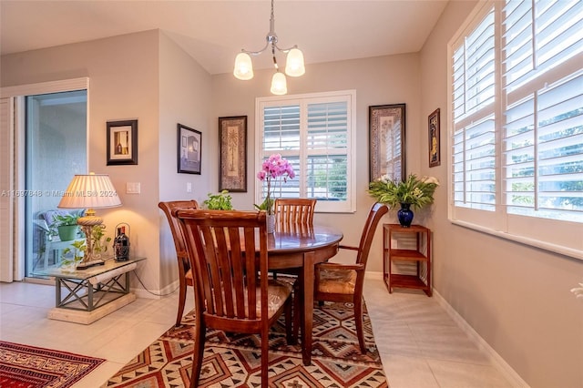 tiled dining area featuring an inviting chandelier