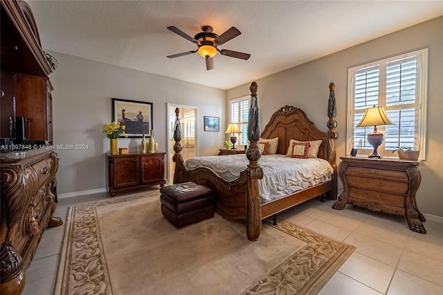 bedroom with light tile patterned floors, a textured ceiling, and ceiling fan