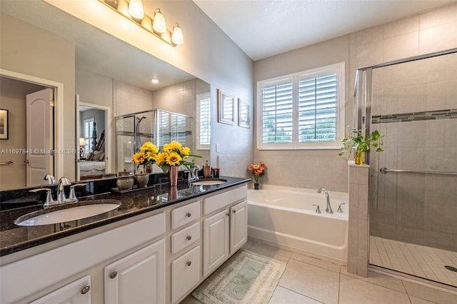 bathroom featuring tile patterned floors, vanity, and plus walk in shower