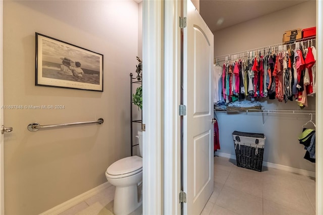 bathroom with tile patterned flooring and toilet