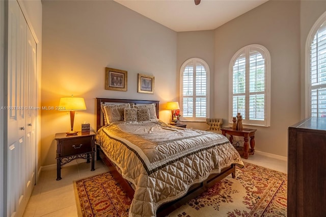 bedroom featuring light tile patterned floors and a closet