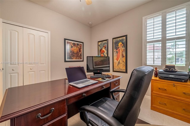 tiled office featuring ceiling fan