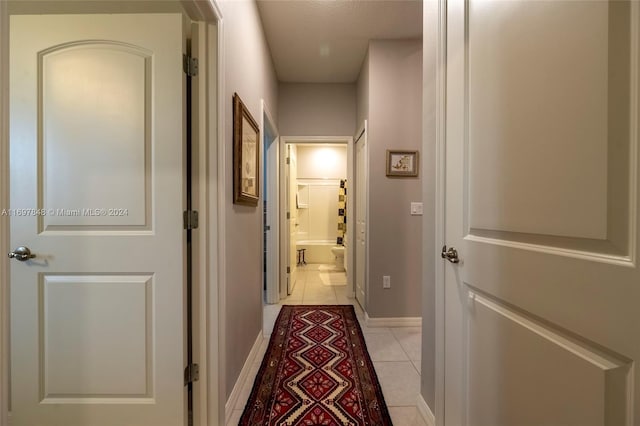 corridor with light tile patterned flooring