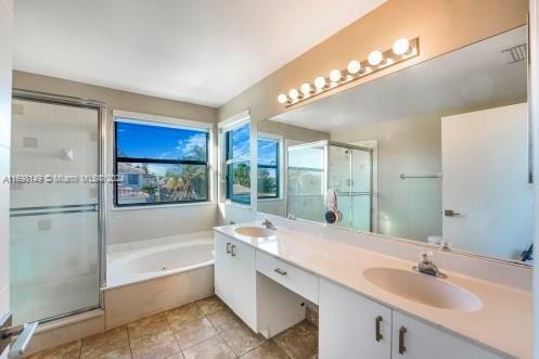 bathroom featuring tile patterned flooring, vanity, and independent shower and bath