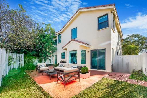 rear view of house with a patio area, outdoor lounge area, and a yard