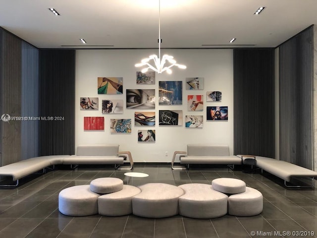 cinema featuring an inviting chandelier and dark tile patterned floors