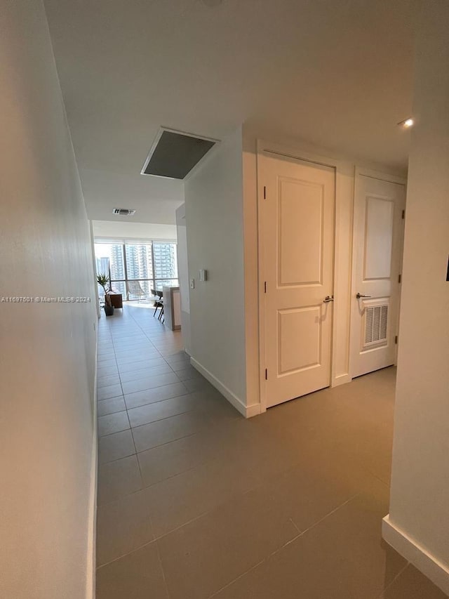 hallway featuring light tile patterned floors