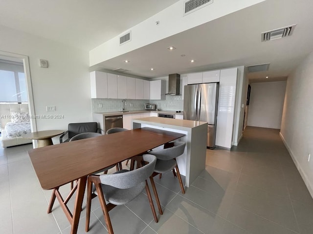 tiled dining space featuring sink