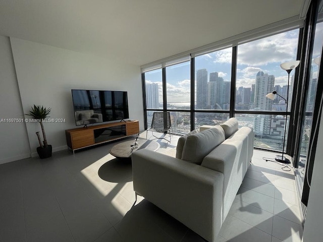 living room featuring light tile patterned flooring and a wall of windows