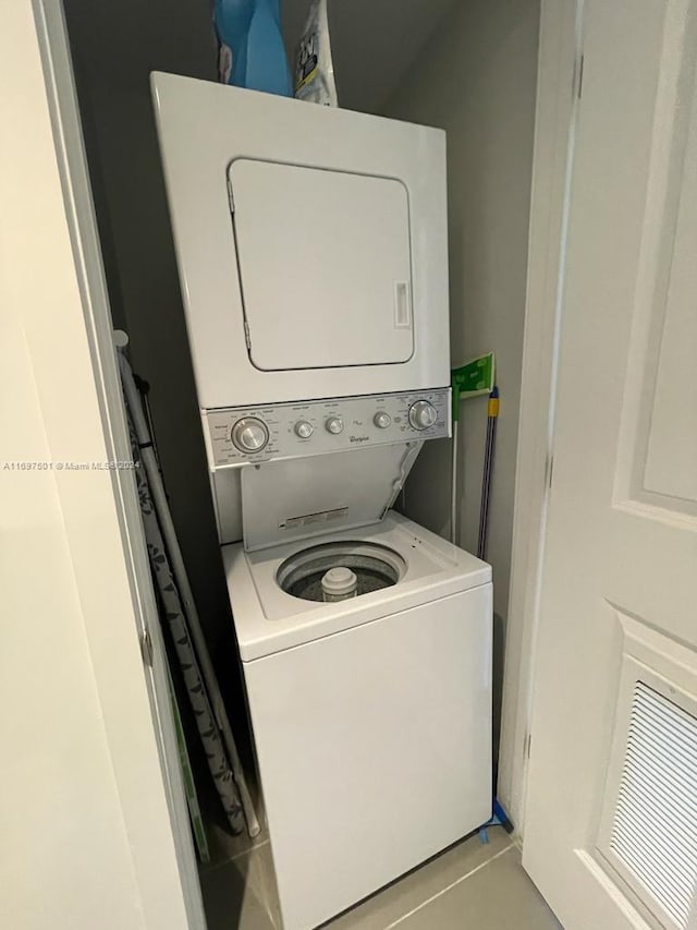 washroom featuring stacked washer and clothes dryer