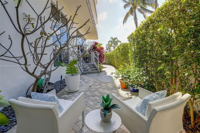 balcony with an outdoor living space and a patio area