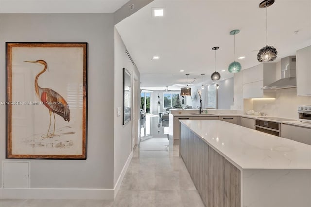 kitchen with wall chimney exhaust hood, sink, a center island, pendant lighting, and oven