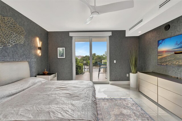 tiled bedroom featuring ceiling fan and access to exterior