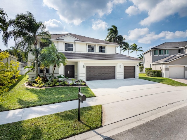 view of front of property featuring a front lawn and a garage