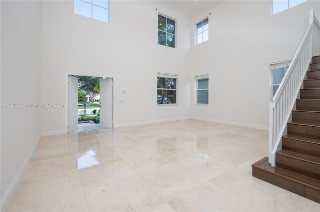 interior space featuring a high ceiling and a wealth of natural light