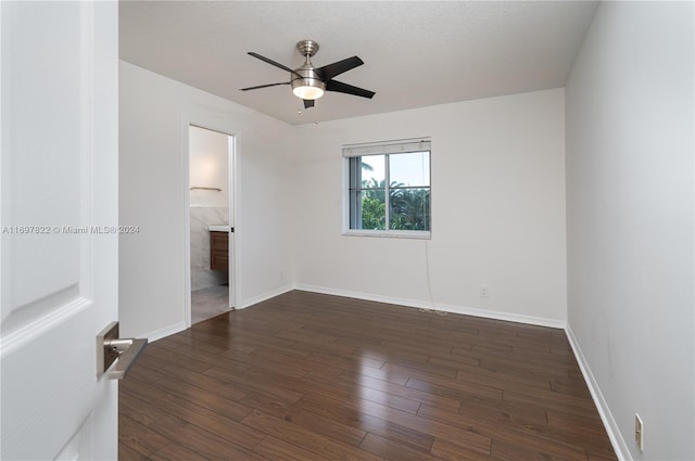 unfurnished room with dark hardwood / wood-style flooring and ceiling fan