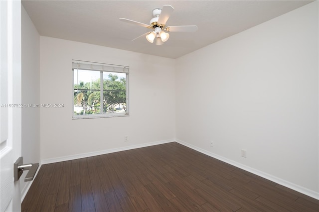 spare room with ceiling fan and dark hardwood / wood-style floors