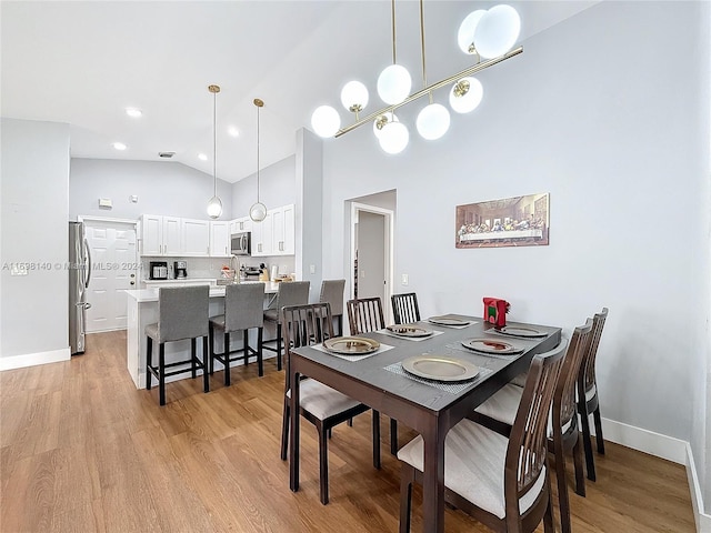 dining room featuring light hardwood / wood-style floors and high vaulted ceiling