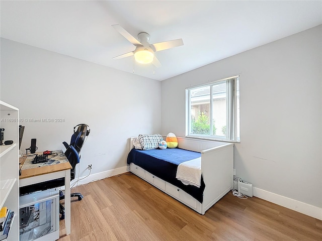 bedroom with light hardwood / wood-style floors and ceiling fan