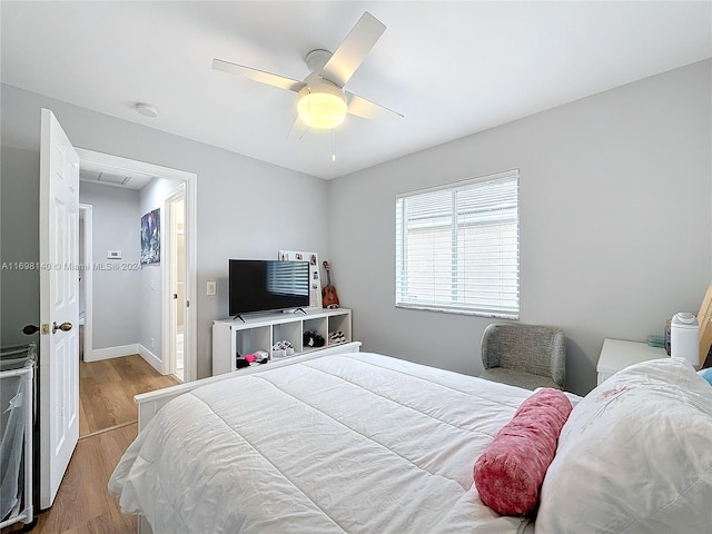 bedroom with light hardwood / wood-style flooring and ceiling fan