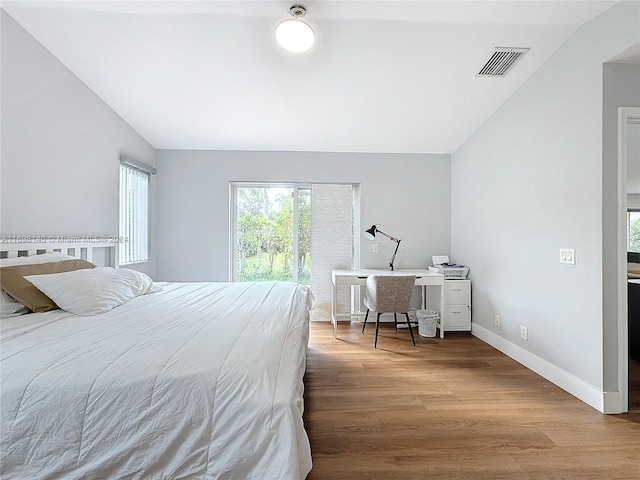 bedroom with light hardwood / wood-style floors and vaulted ceiling