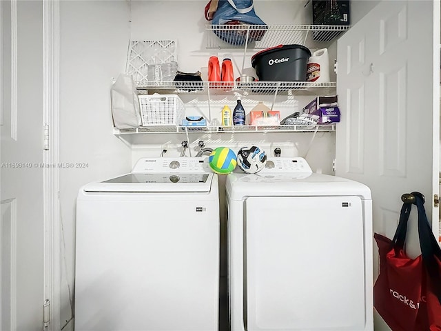 clothes washing area with washing machine and dryer