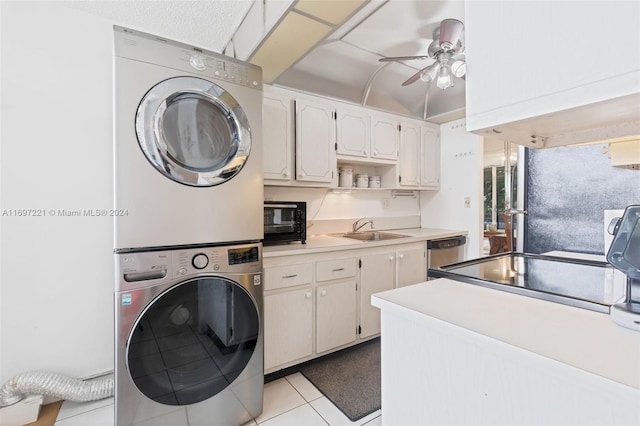 washroom with ceiling fan, stacked washer and dryer, light tile patterned floors, and sink