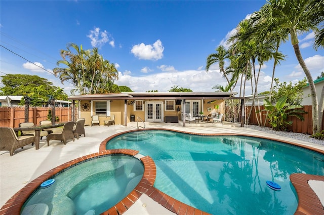 view of swimming pool with an in ground hot tub, french doors, and a patio