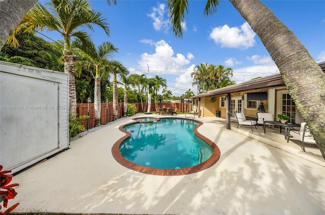 1458 Rodman St, Hollywood, FL 33020 - view of swimming pool featuring french doors, a patio area, a fenced backyard, and a pool with connected hot tub
