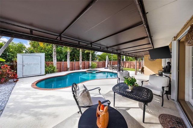 view of pool featuring an in ground hot tub and a patio