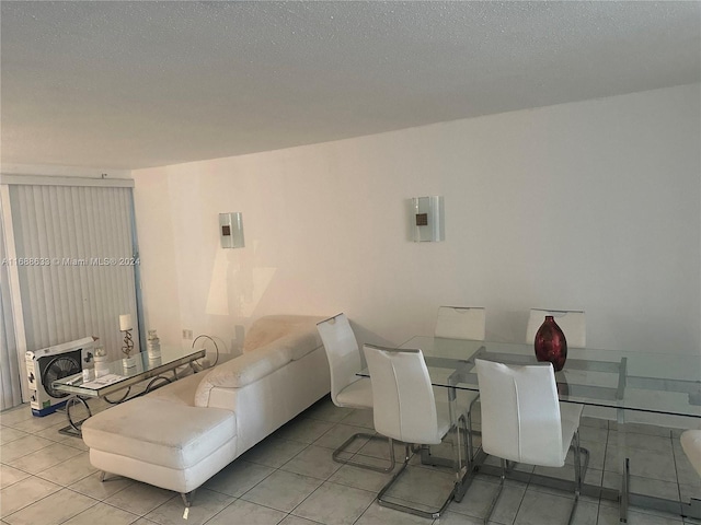 tiled dining area featuring a textured ceiling