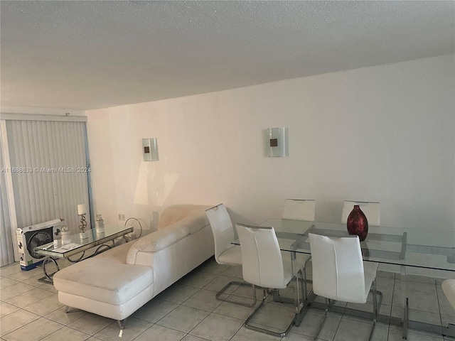 1660 NE 191st St Unit 211-1, Miami, FL 33179 - dining space featuring tile patterned flooring, heating unit, and a textured ceiling
