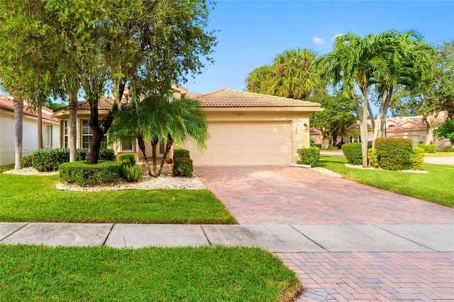 mediterranean / spanish-style home with a front yard and a garage