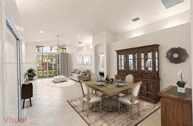 tiled dining room with ceiling fan and lofted ceiling