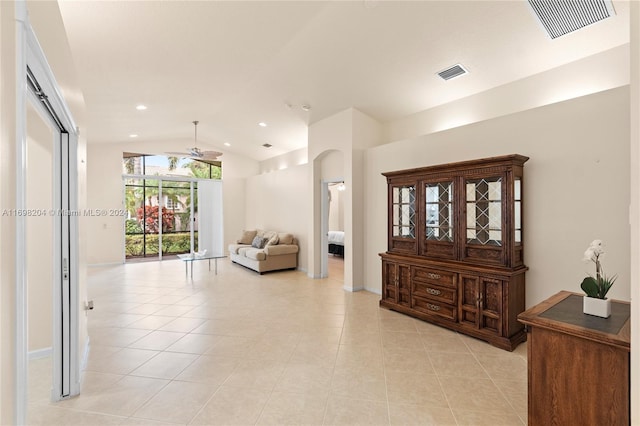 interior space featuring light tile patterned flooring and lofted ceiling