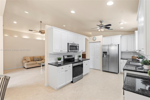 kitchen with white cabinetry, sink, stainless steel appliances, tasteful backsplash, and lofted ceiling